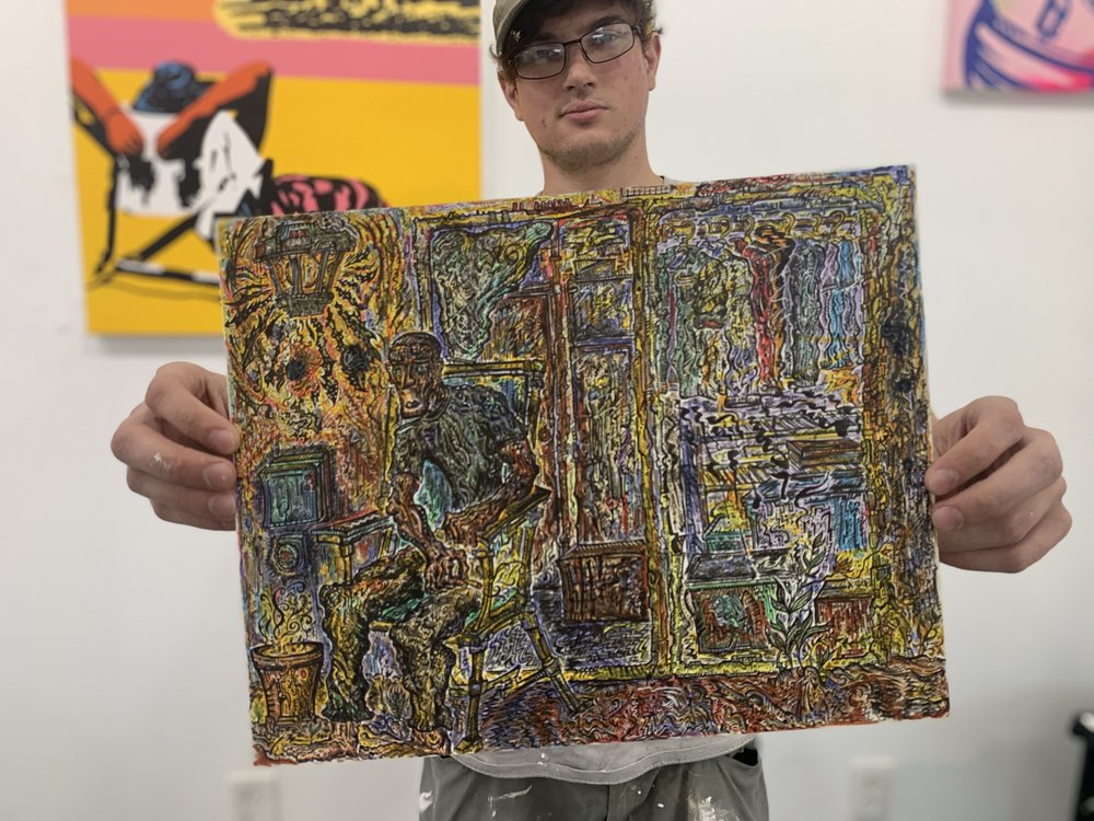 Andrew Kisler a.k.a. Blunt Force Trauma Ink holding one of his pieces